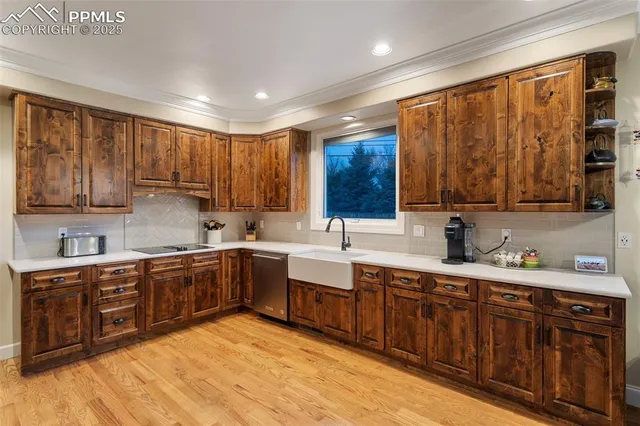 a kitchen with a sink wooden cabinets and stainless steel appliances