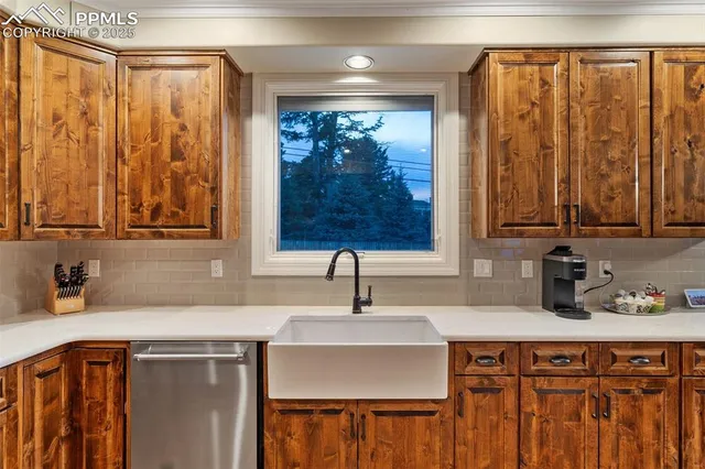 a kitchen with stainless steel appliances a sink and a cabinets