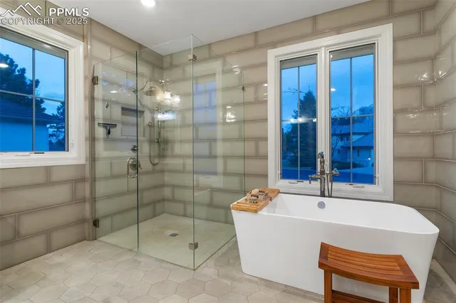 a bathroom with a bathtub and shower
