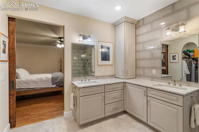 a en suite bathroom with a sink double vanity and a mirror