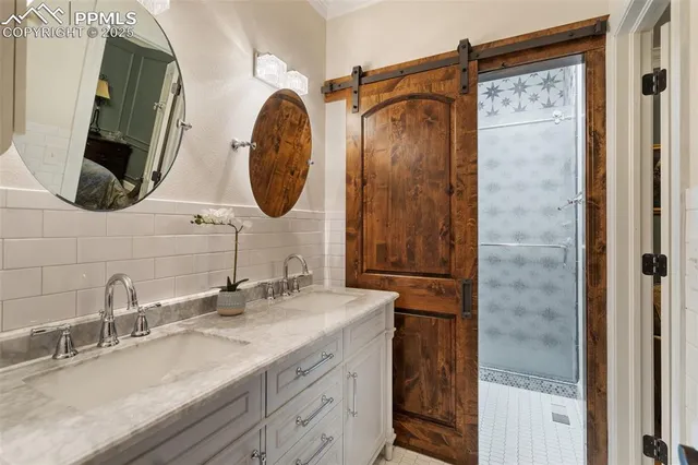 a bathroom with a double vanity sink mirror and bathtub