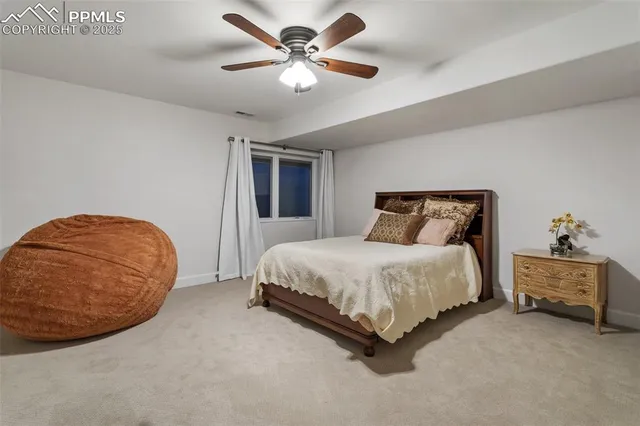 a spacious bedroom with a bed and a chandelier