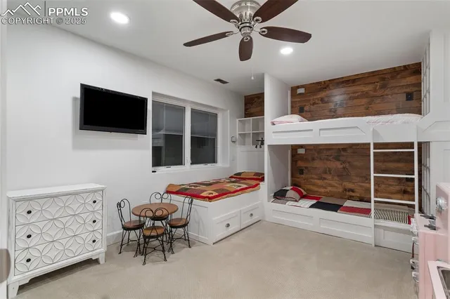 a bedroom with furniture and a flat screen tv