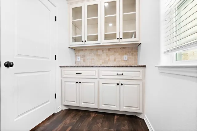 a view of a room with rack on the wall and a window