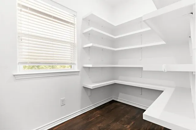 a spacious bedroom with a bed and a chandelier