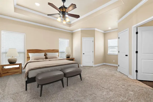 a bedroom with a large bed and a chandelier