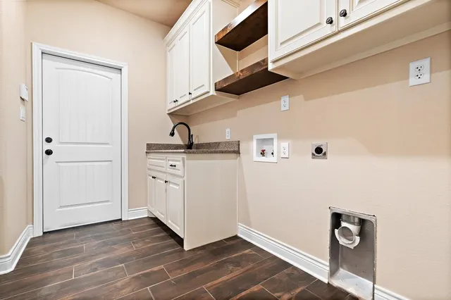 a view of an empty room with closet and a window