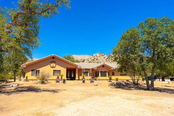 a kitchen with stainless steel appliances granite countertop a sink a stove and a wooden floors