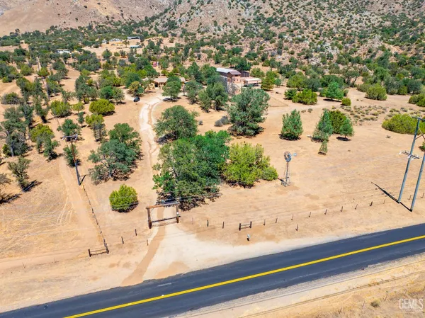 an aerial view of residential houses with yard