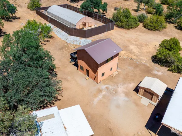 an aerial view of a house with yard swimming pool and outdoor seating