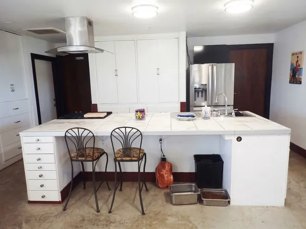 a kitchen with a stove and a refrigerator