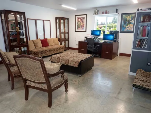 a view of a livingroom with furniture and a large window