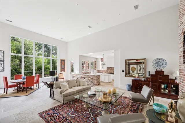 a living room with furniture couches and a large window