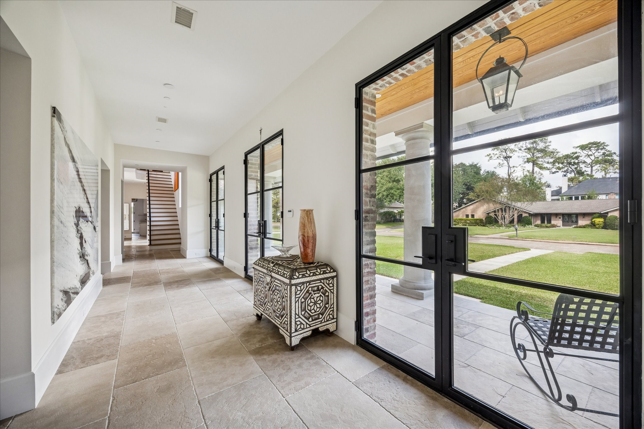7 Hedwig Shadows Lane Houston, TX 77024 - Photo 3 of 46 This artful entryway defines modern refinement—clean lines, natural textures, and curated scale. The interplay between brick, stone, and glass speaks to the architect’s vision of timeless simplicity and structural beauty.