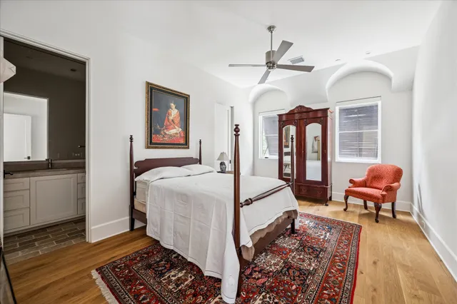 a bedroom with furniture and wooden floor