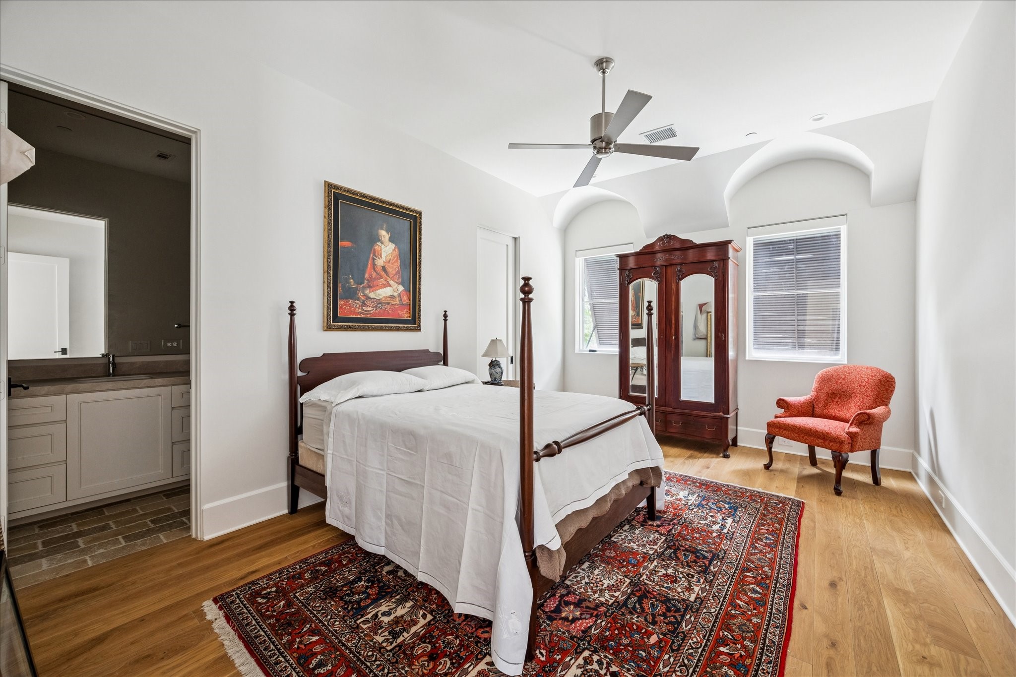 7 Hedwig Shadows Lane Houston, TX 77024 - Photo 33 of 46 Peaceful and elegant, this secondary bedroom features vaulted ceilings, custom millwork, and light oak flooring. Arched windows softly frame garden views.