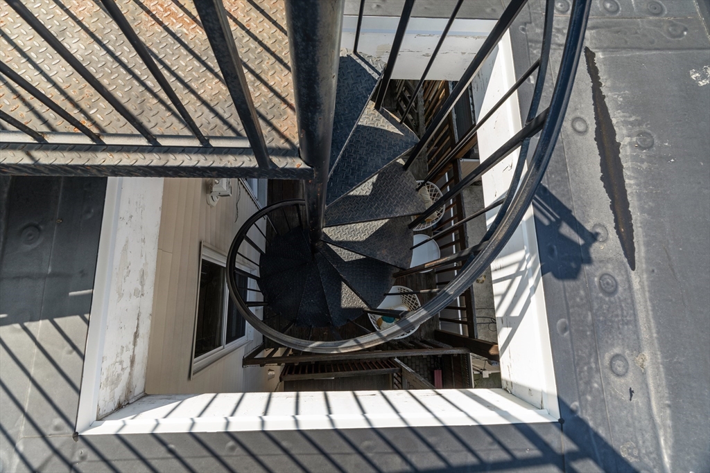 15 I Street, Unit 3 Boston, MA 02127 - Photo 14 of 17 a view of staircase with wooden floor and chair
