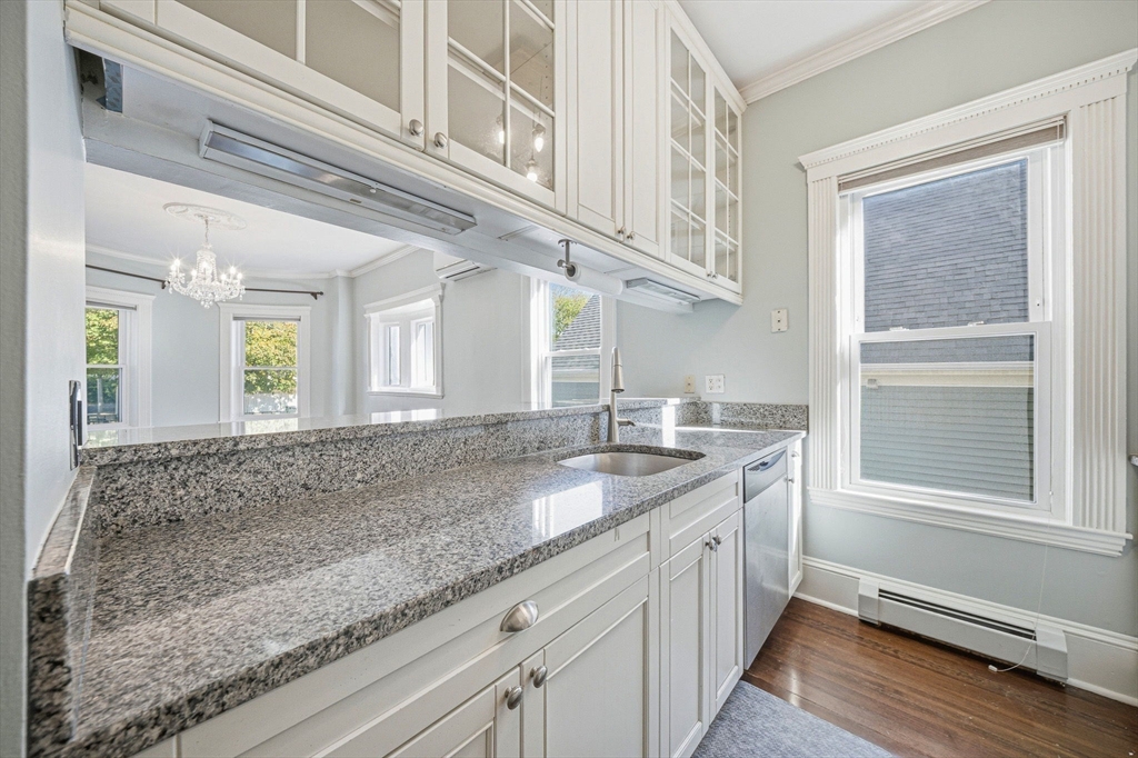 33 Adams Street, Unit 1 Boston, MA 02122 - Photo 12 of 36 a bathroom with a granite countertop sink and a window