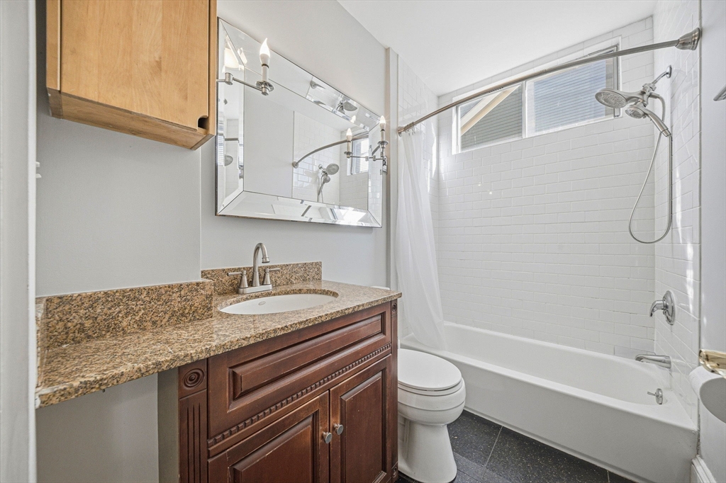 33 Adams Street, Unit 1 Boston, MA 02122 - Photo 16 of 36 a bathroom with a granite countertop sink toilet and shower
