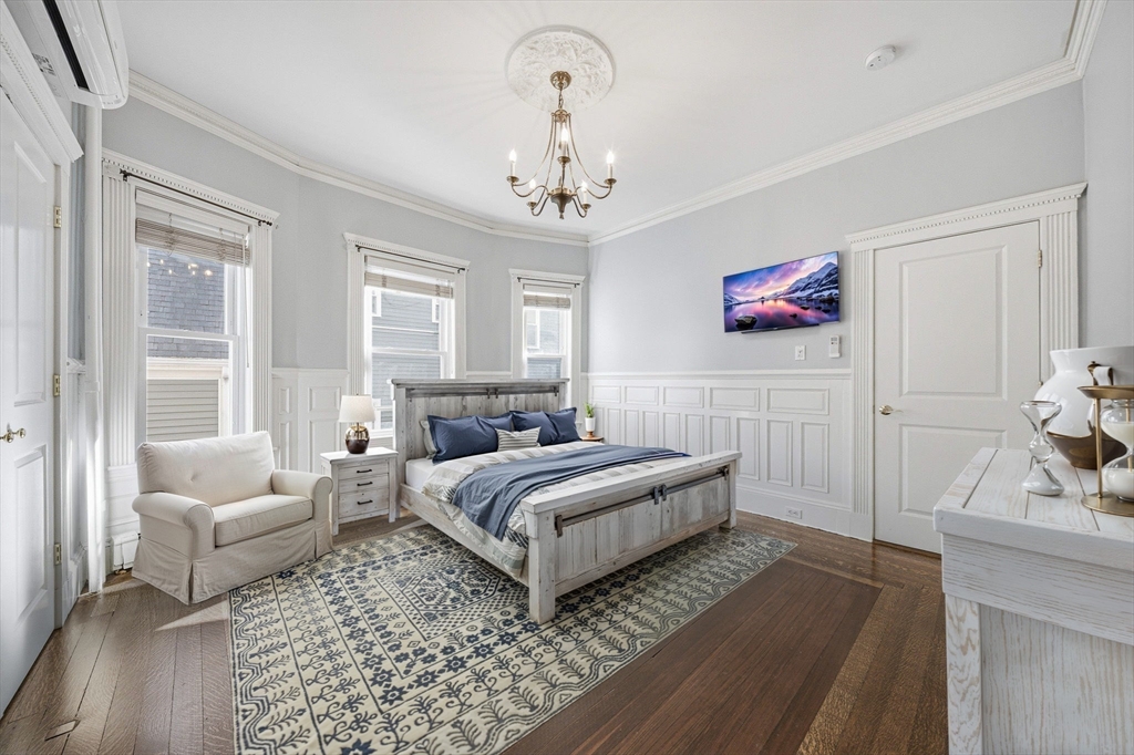 33 Adams Street, Unit 1 Boston, MA 02122 - Photo 17 of 36 a spacious bedroom with a bed and a couch