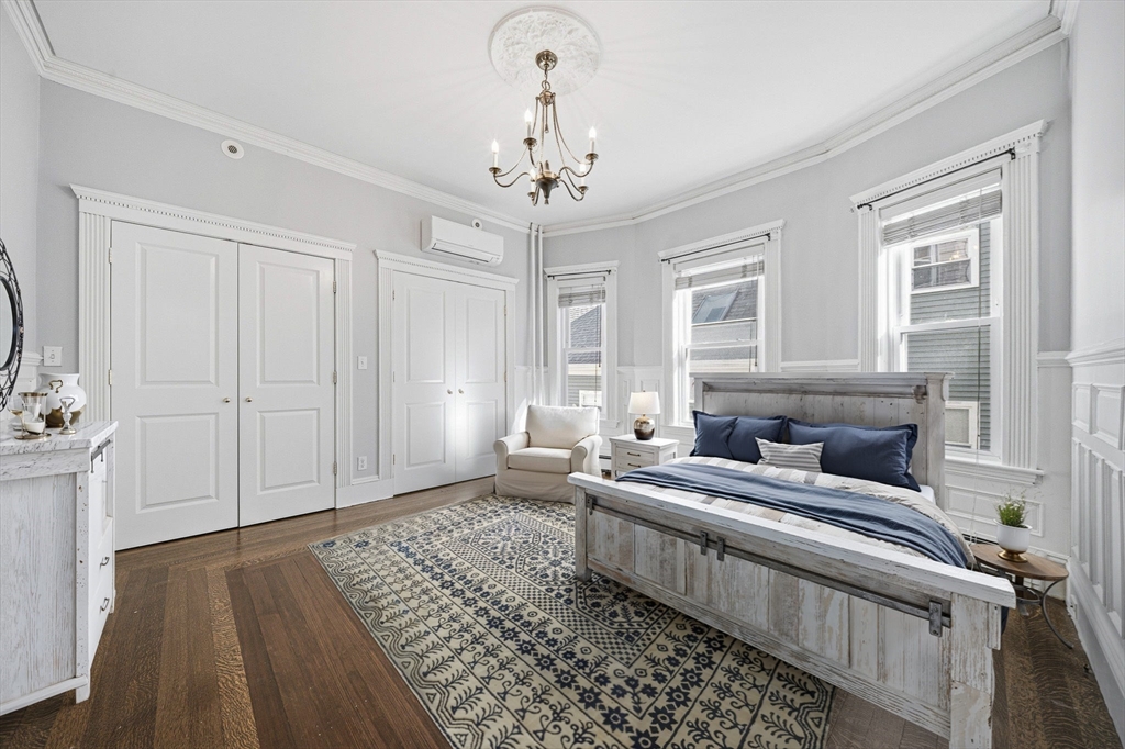 33 Adams Street, Unit 1 Boston, MA 02122 - Photo 19 of 36 a living room with furniture and a chandelier