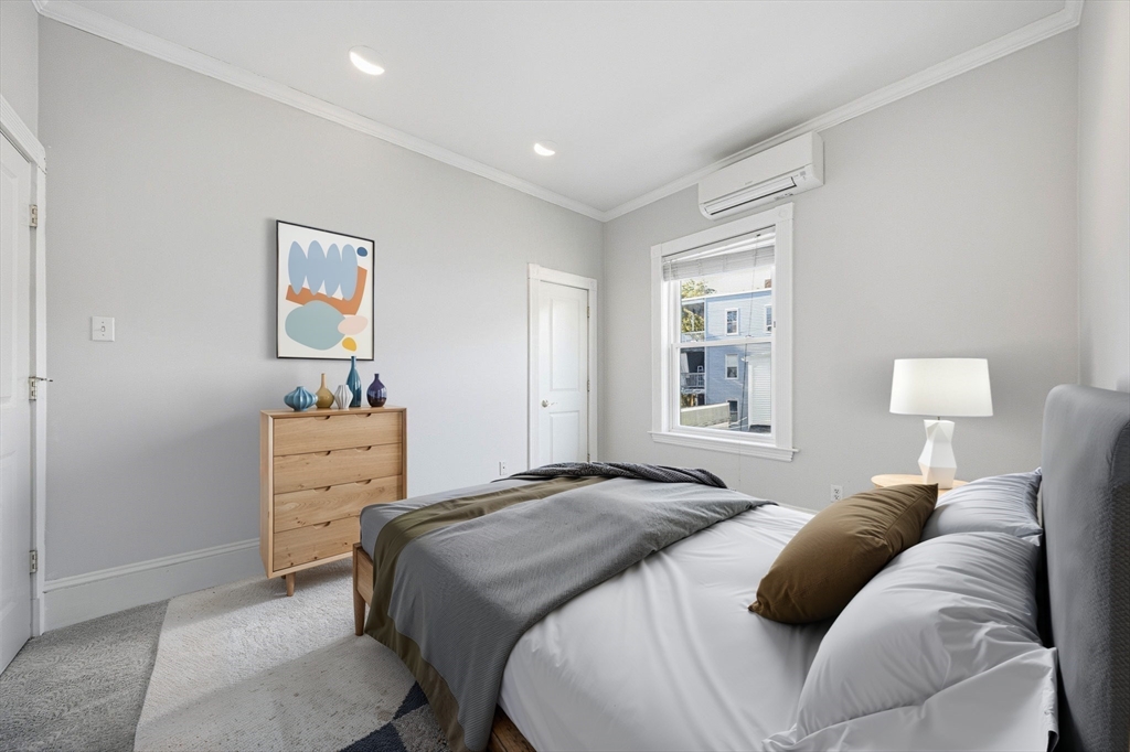 33 Adams Street, Unit 1 Boston, MA 02122 - Photo 23 of 36 a bedroom with a bed and a dresser