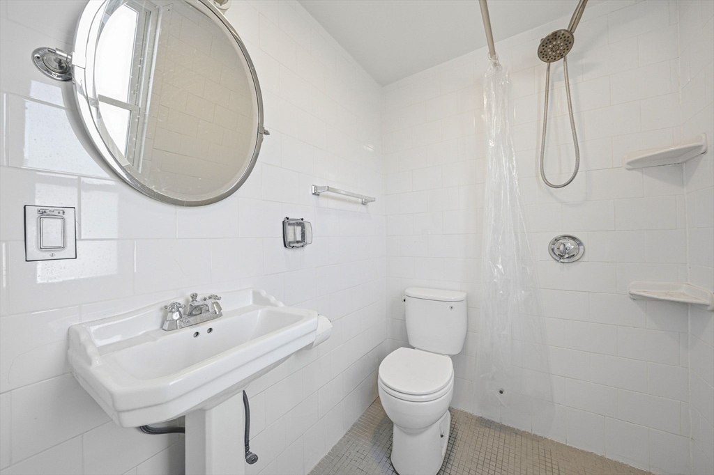 33 Adams Street, Unit 1 Boston, MA 02122 - Photo 24 of 36 a bathroom with a sink a toilet and a mirror