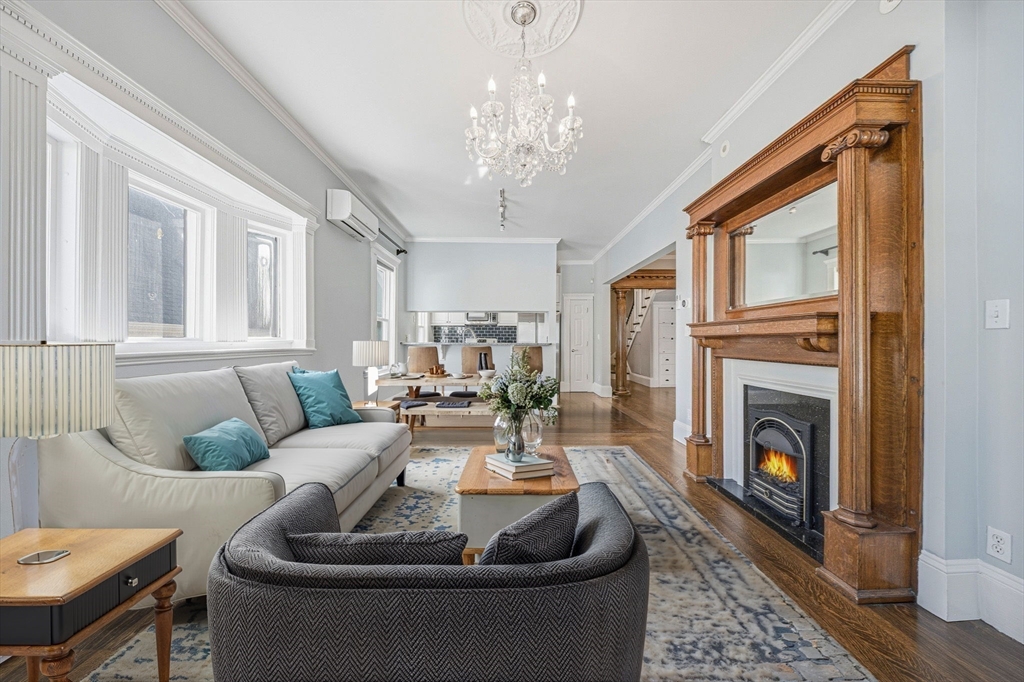 33 Adams Street, Unit 1 Boston, MA 02122 - Photo 3 of 36 a living room with furniture a fireplace and a chandelier