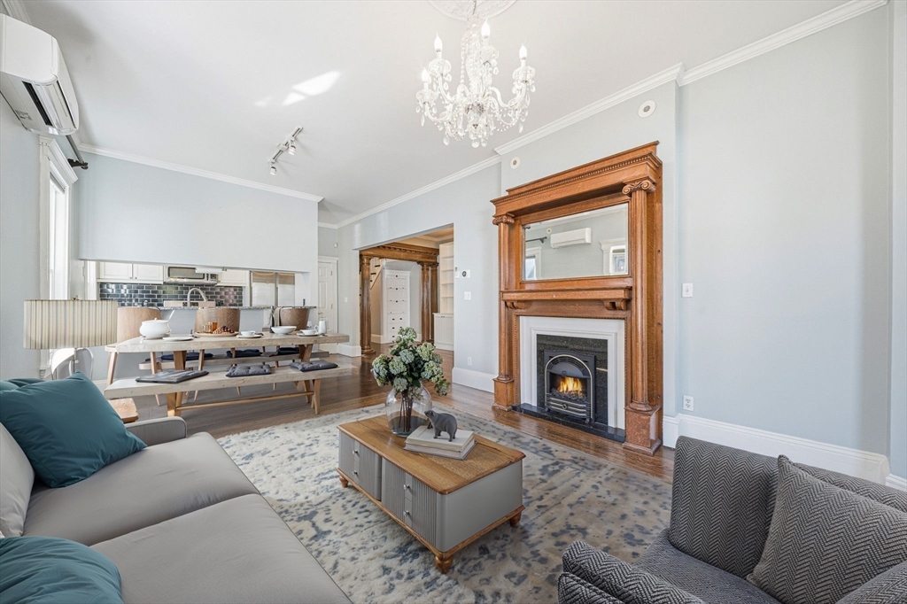 33 Adams Street, Unit 1 Boston, MA 02122 - Photo 4 of 36 a living room with furniture a fireplace and a chandelier