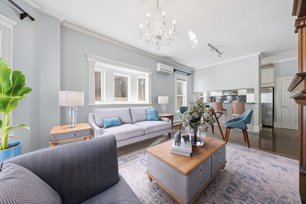 33 Adams Street, Unit 1 Boston, MA 02122 - Photo 6 of 36 a living room with furniture and a chandelier