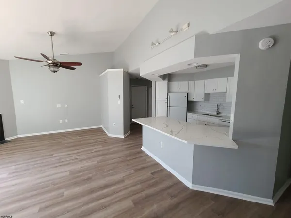 a kitchen with a sink a stove a refrigerator and white cabinets