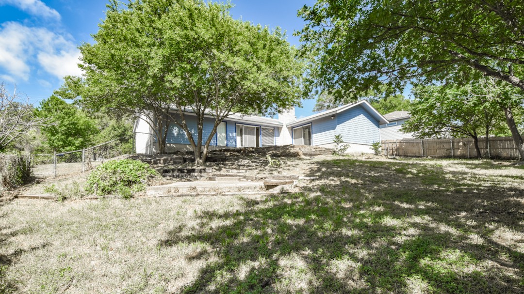 910 Rocky Spring Road Austin, TX 78753 - Photo 25 of 26 a front view of house with yard and trees around