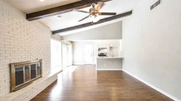 wooden floor in an empty room with a fireplace