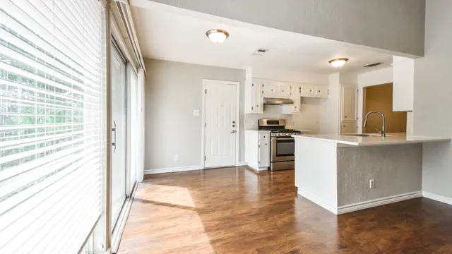 a kitchen with a refrigerator and a sink