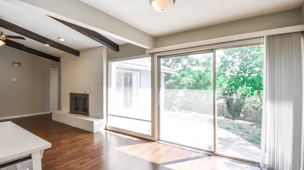a view of a room with wooden floor and windows