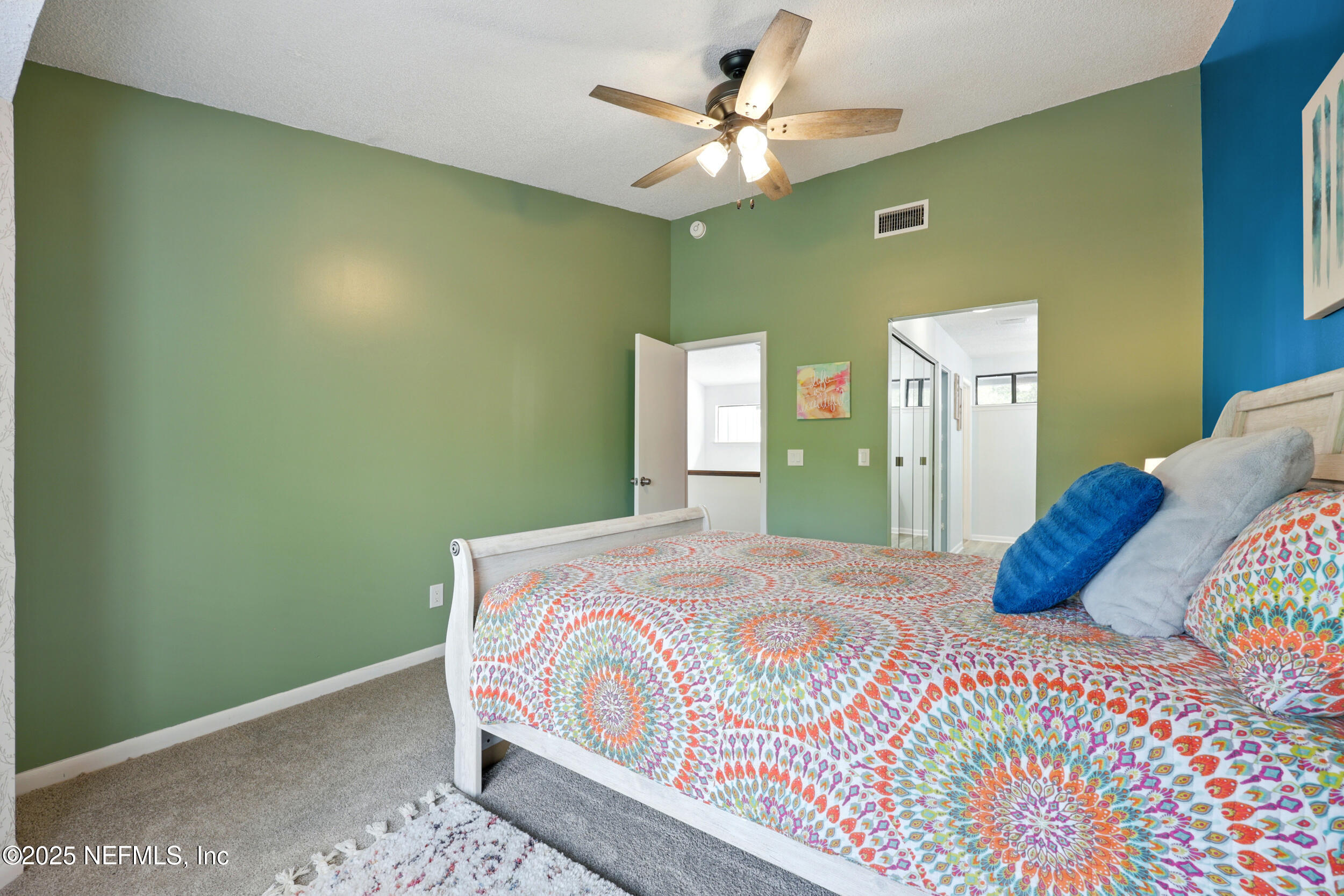 9360 Craven Road, Unit 1406 Jacksonville, FL 32257 - Photo 18 of 30 a bedroom with a bed and a chandelier