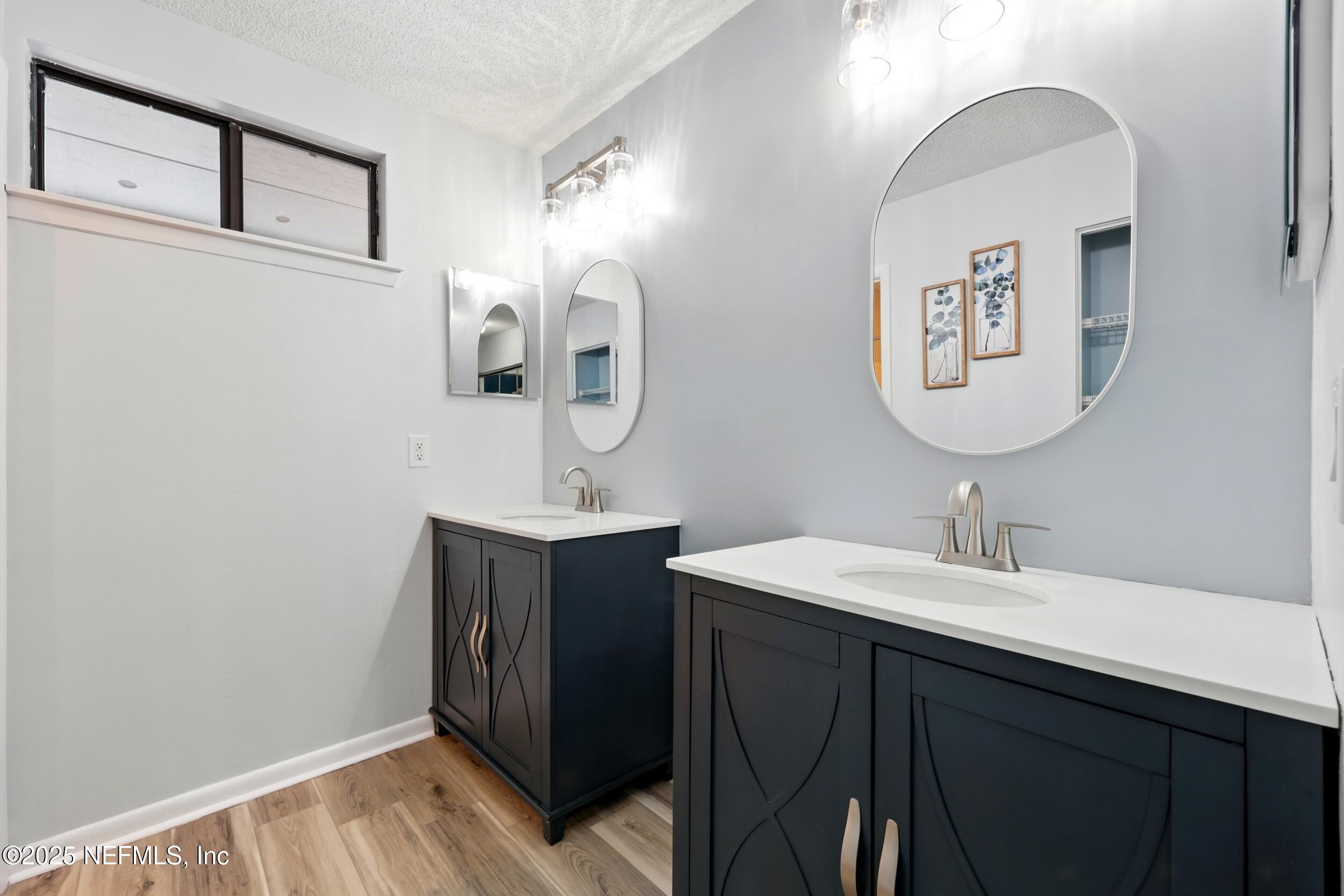 9360 Craven Road, Unit 1406 Jacksonville, FL 32257 - Photo 19 of 30 a bathroom with a sink and a mirror