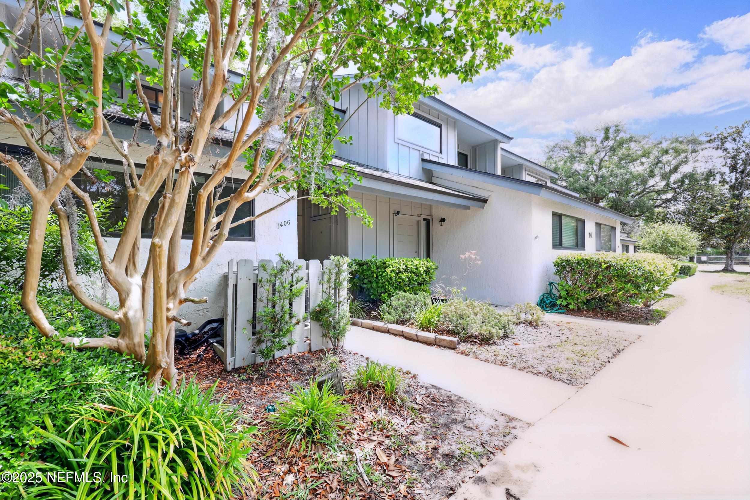 9360 Craven Road, Unit 1406 Jacksonville, FL 32257 - Photo 28 of 30 a front view of a house with a yard and plant