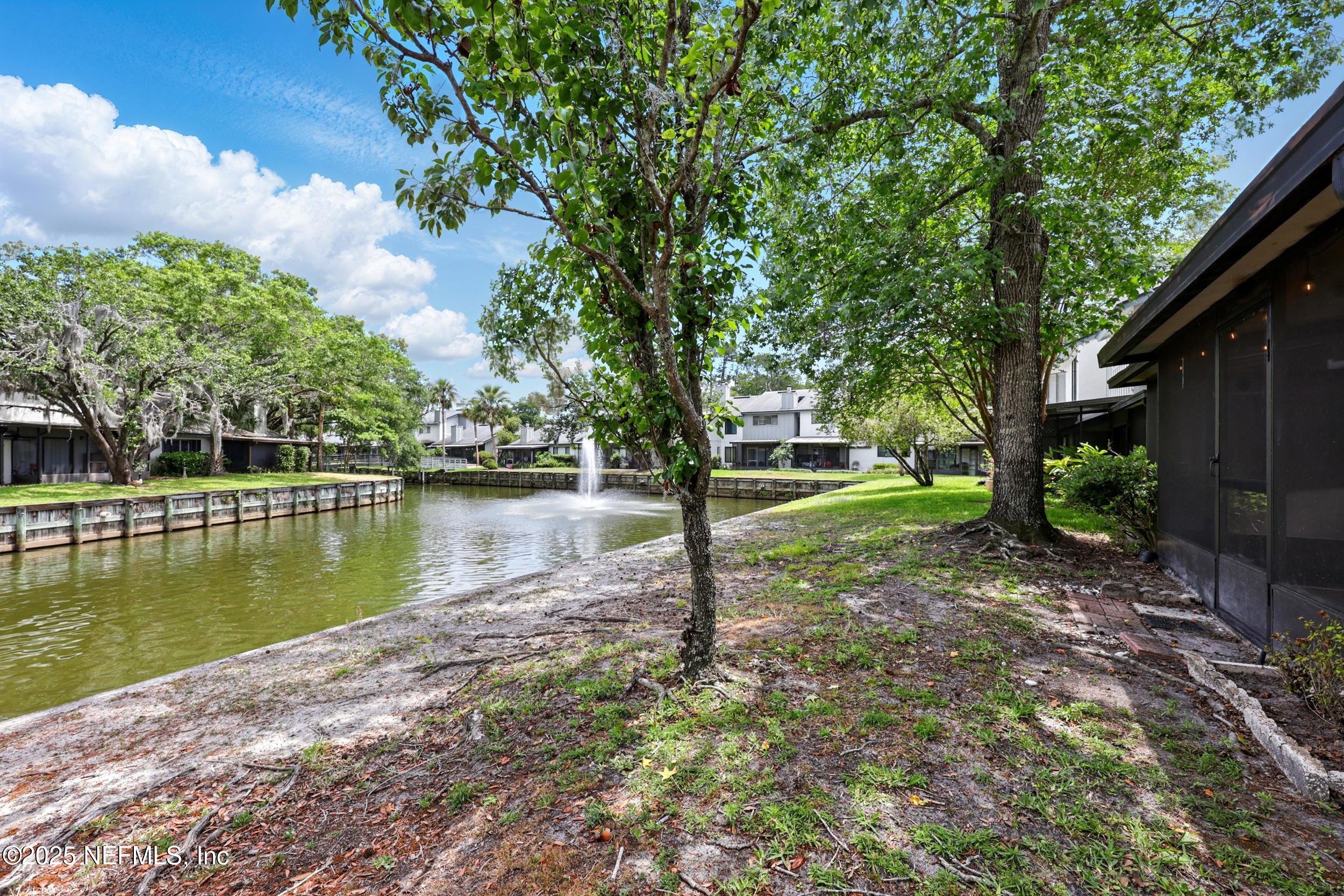 9360 Craven Road, Unit 1406 Jacksonville, FL 32257 - Photo 5 of 30 a view of a lake with a house in the background