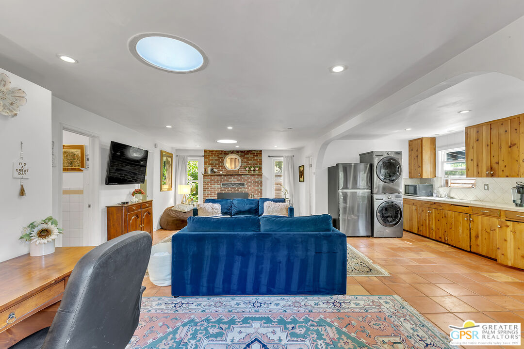 25300 Tahquitz Road Idyllwild, CA 92549 - Photo 11 of 75 a living room with furniture a flat screen tv and kitchen view