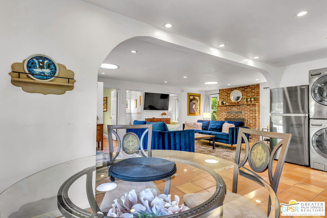 25300 Tahquitz Road Idyllwild, CA 92549 - Photo 26 of 75 a living room with furniture a dining table and a fireplace