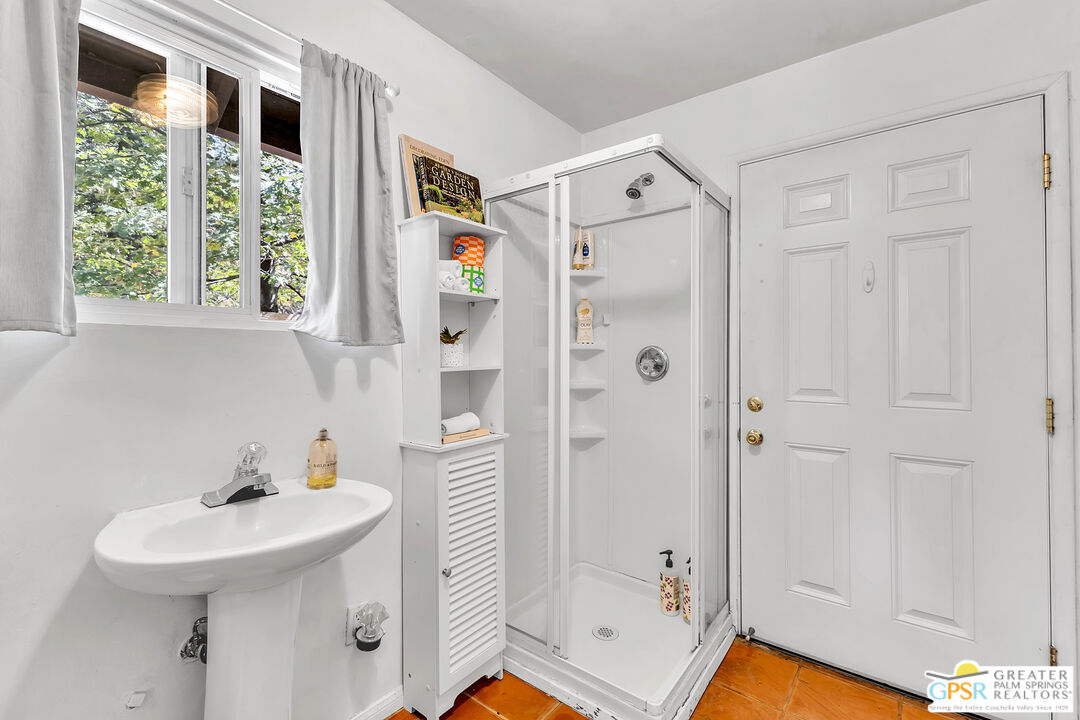 25300 Tahquitz Road Idyllwild, CA 92549 - Photo 36 of 75 a bathroom with a sink a mirror a window and shower