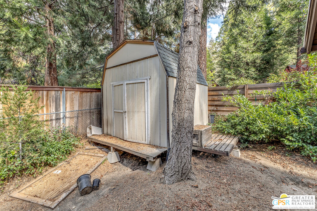 25300 Tahquitz Road Idyllwild, CA 92549 - Photo 41 of 75 a backyard of a house with table and chairs