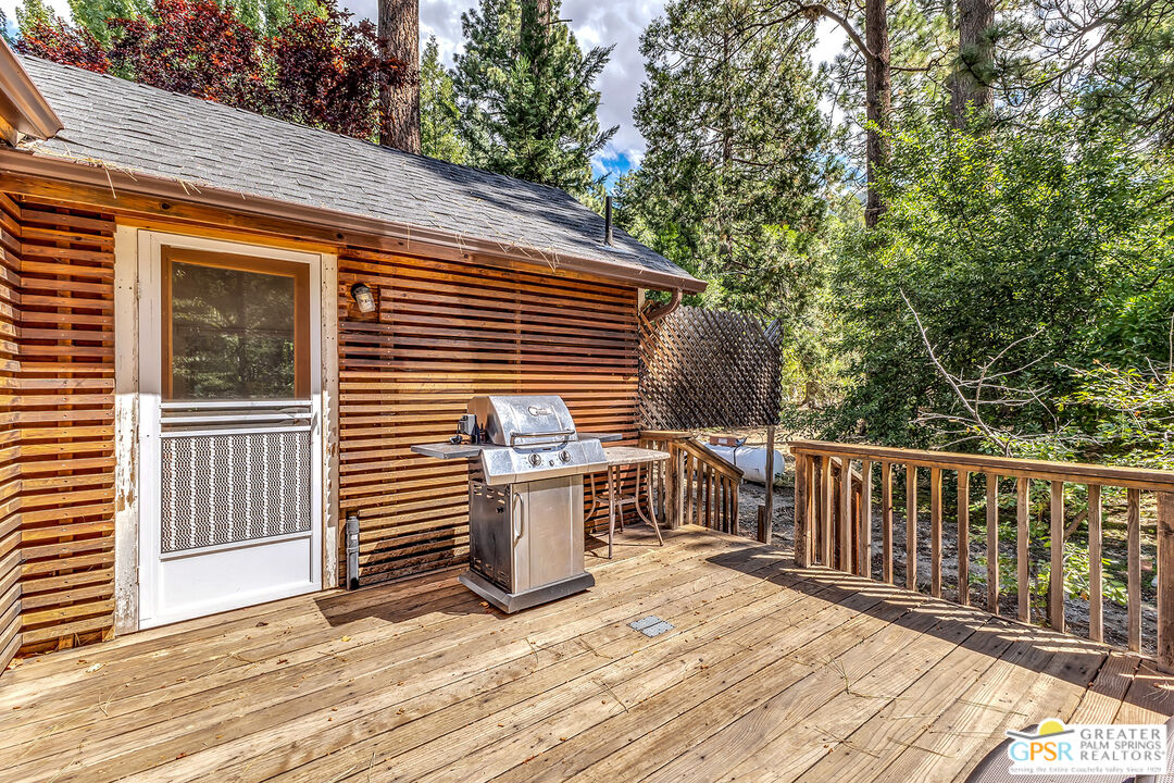 25300 Tahquitz Road Idyllwild, CA 92549 - Photo 57 of 75 a view of a deck with a floor to ceiling window and wooden fence