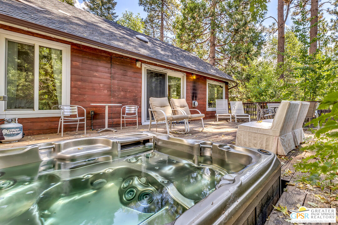 25300 Tahquitz Road Idyllwild, CA 92549 - Photo 6 of 75 a view of a patio with table and chairs and potted plants with large tree