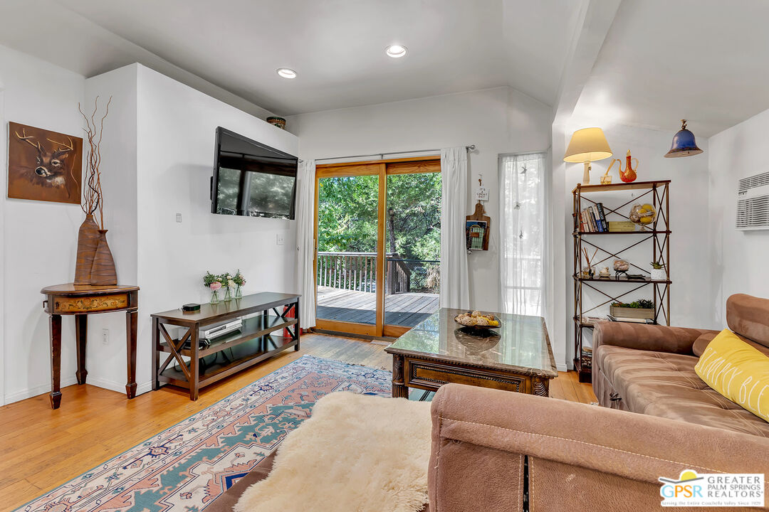 25300 Tahquitz Road Idyllwild, CA 92549 - Photo 65 of 75 a living room with furniture and a flat screen tv