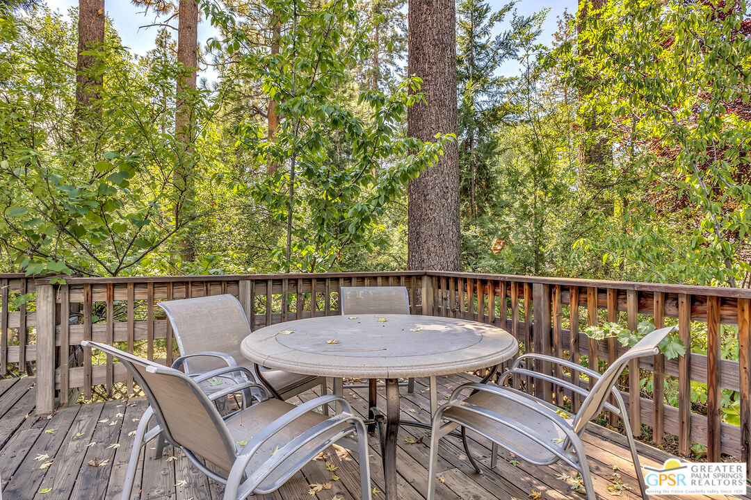25300 Tahquitz Road Idyllwild, CA 92549 - Photo 9 of 75 a view of a balcony with a table and chairs
