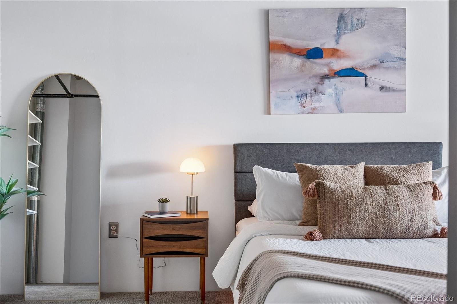 3457 Ringsby Court, Unit 347 Denver, CO 80216 - Photo 11 of 22 a bedroom with a bed and a couch