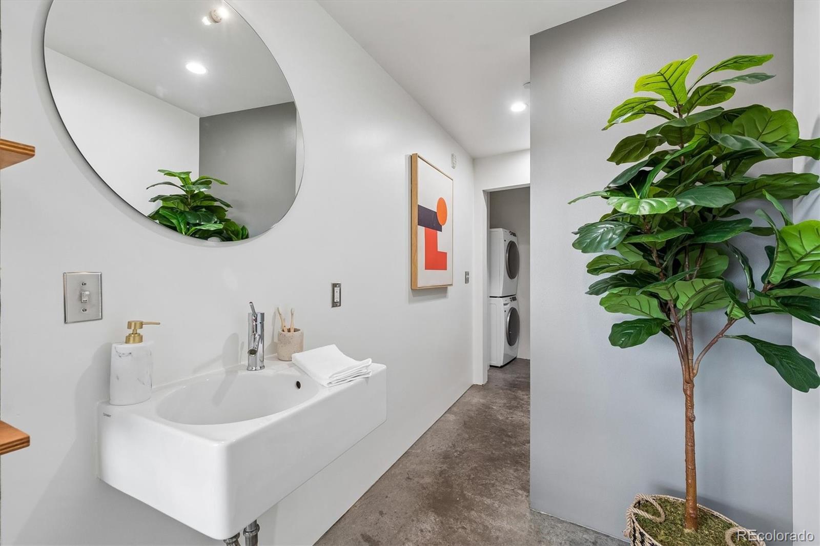 3457 Ringsby Court, Unit 347 Denver, CO 80216 - Photo 15 of 22 a white bath tub sitting in a bathroom
