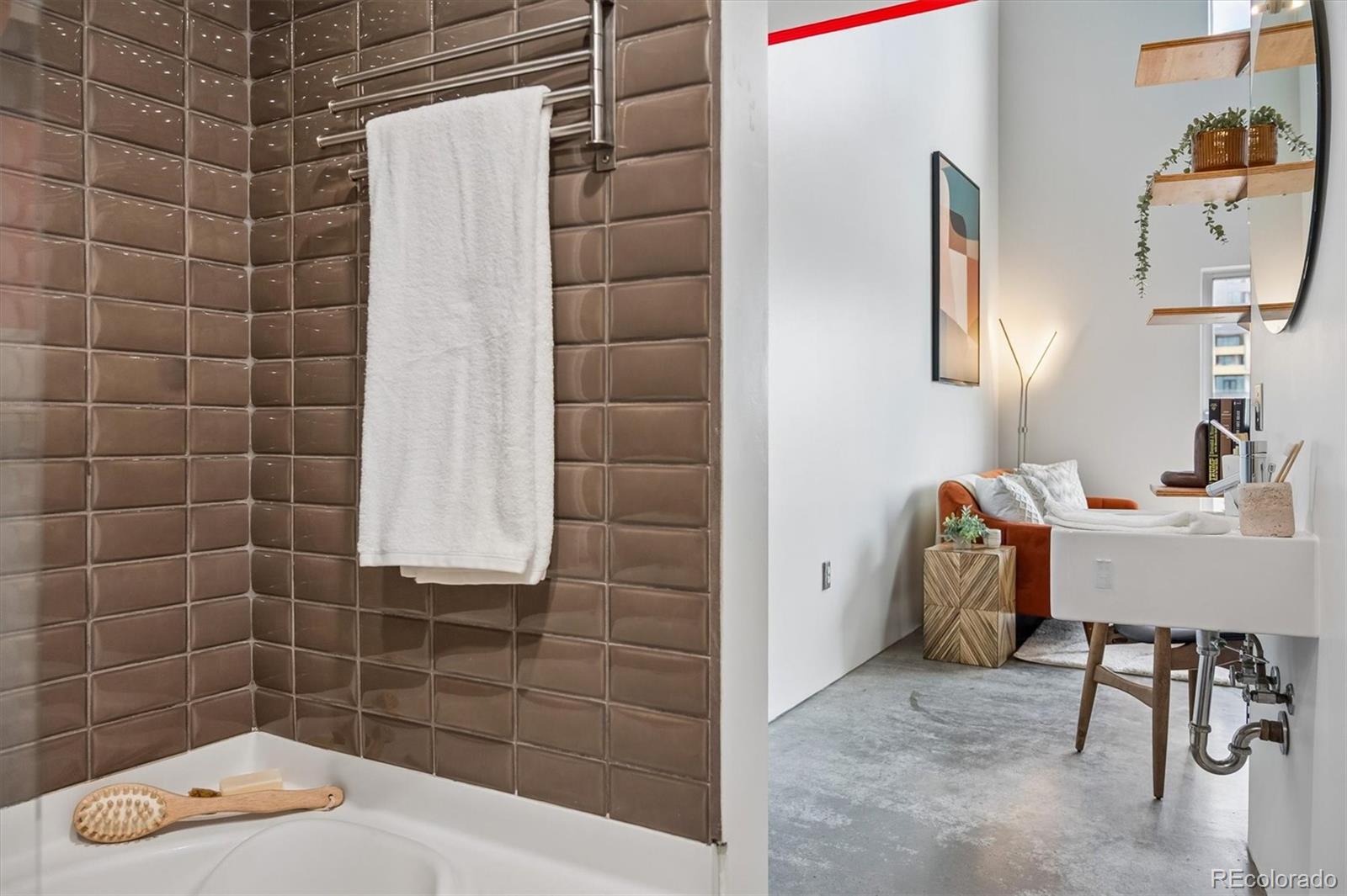 3457 Ringsby Court, Unit 347 Denver, CO 80216 - Photo 17 of 22 a bathroom with a sink toilet and shower